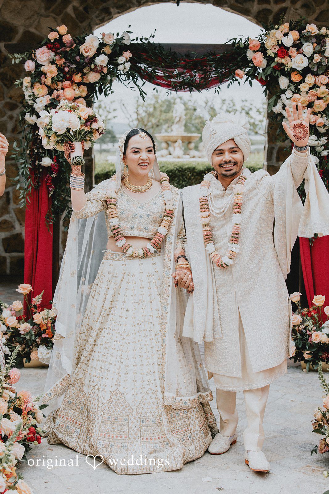 Chandrakant + Sumbul Bride and groom walking hand in hand after the ceremony
