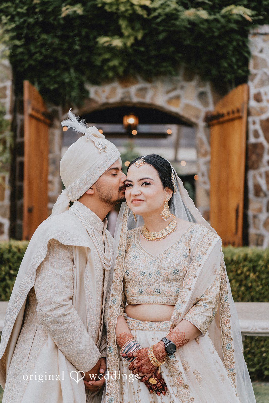 Chandrakant + Sumbul Bride and groom sharing a kiss during romantic wedding portraits