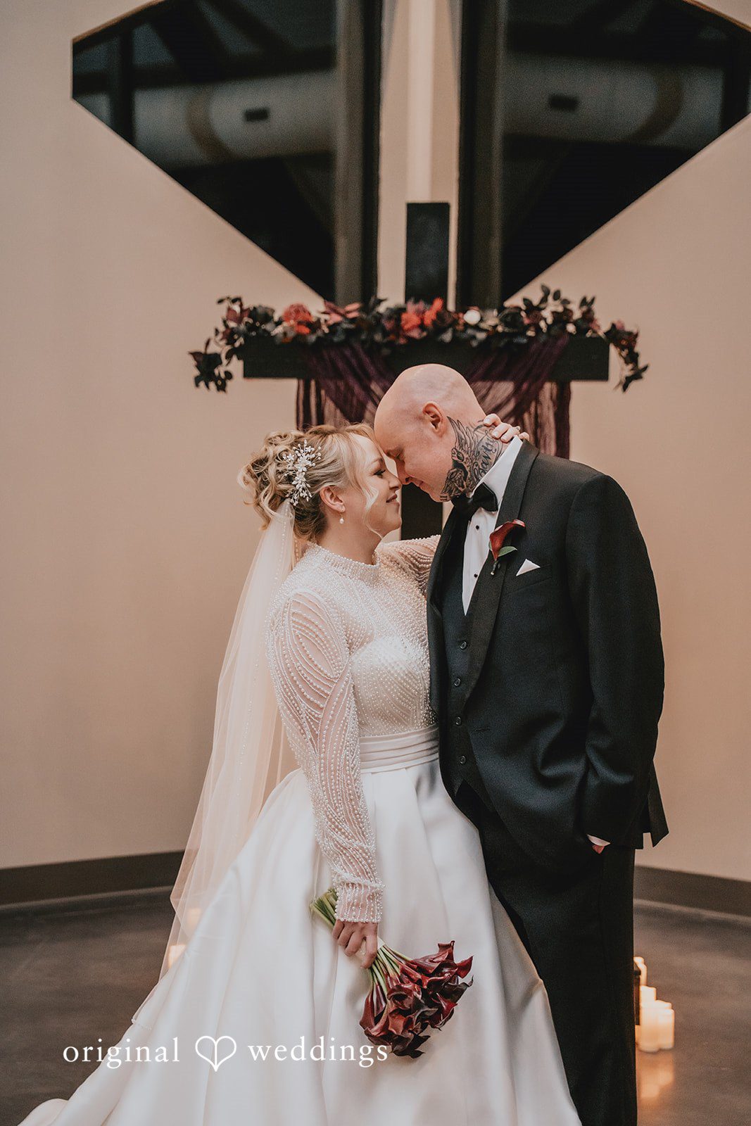 Groom leaning forehead against smiling bride.