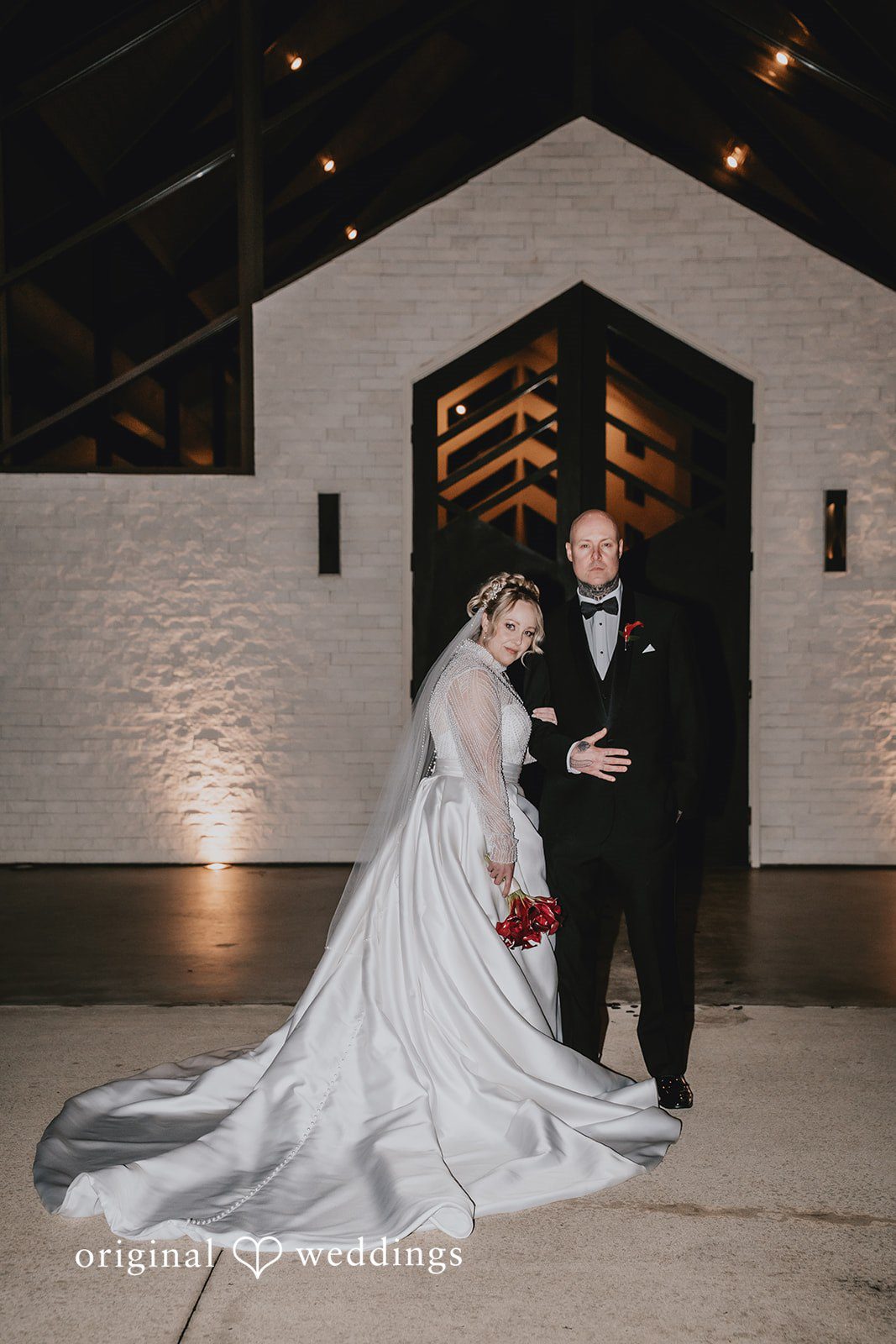 Bride and groom posing by a dark entrance at Jennings trace.