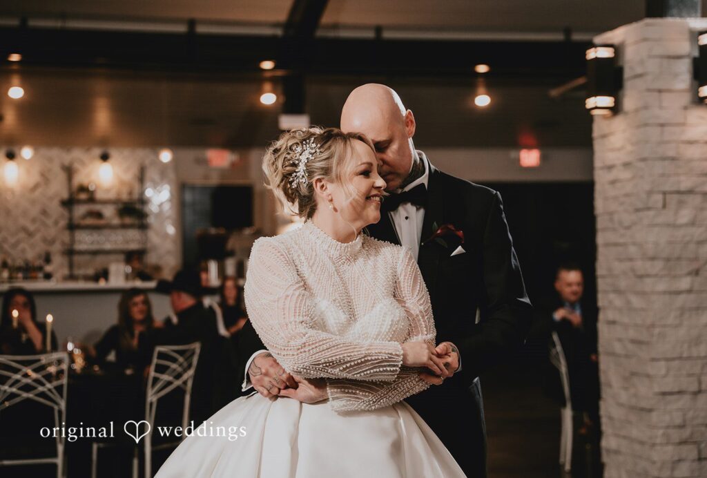 Krista + Darrell Newlyweds sharing a slow dance while embracing closely.