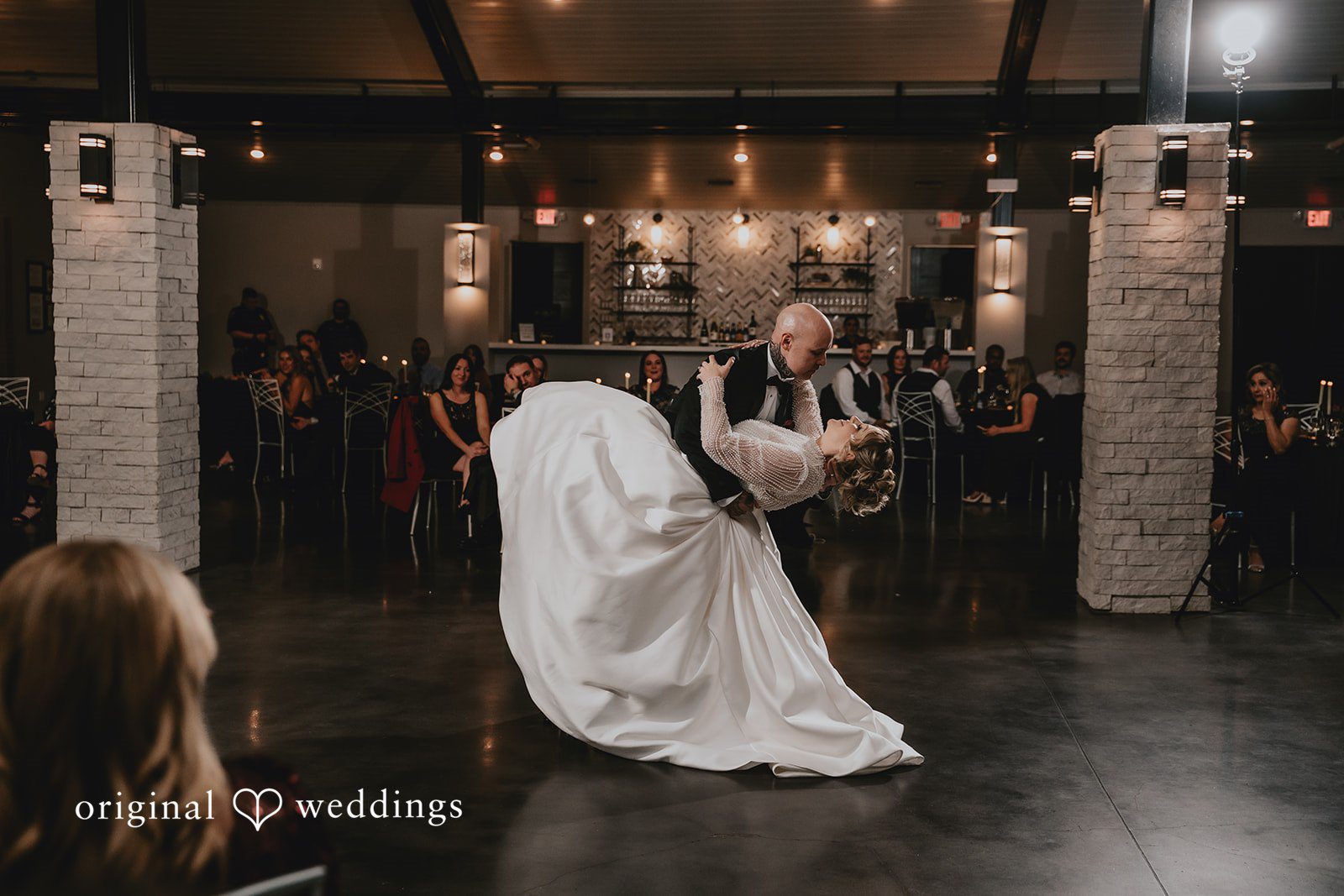 Bride dancing in a large hall during reception.