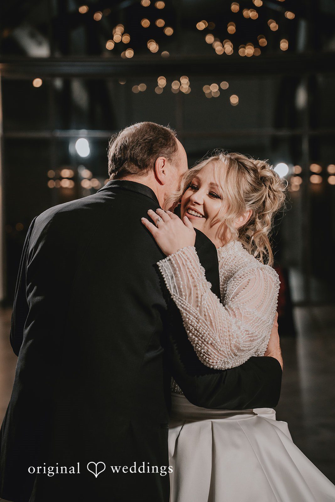 Newlyweds sharing a slow dance while embracing closely.