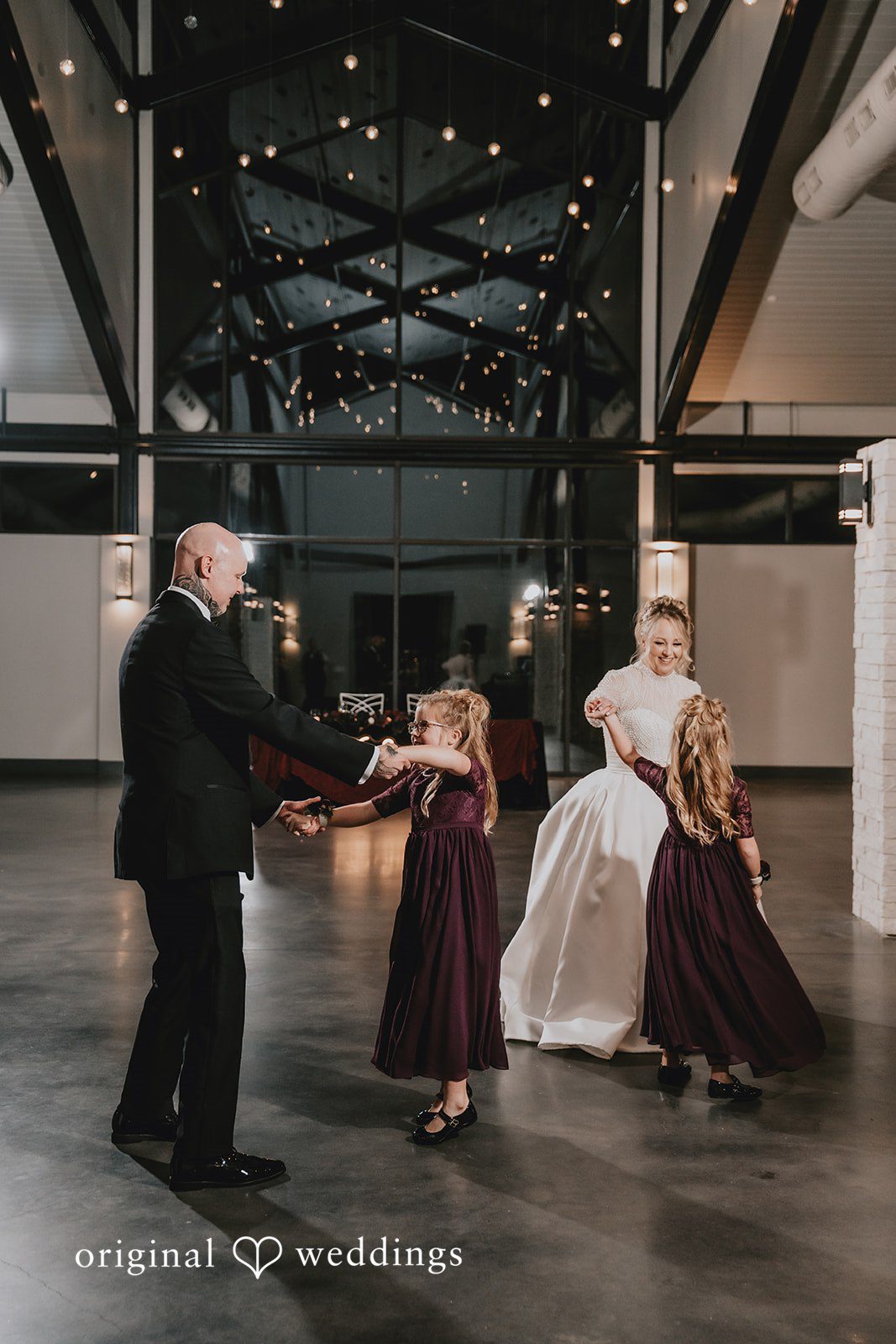 Groom dipping and dancing with his smiling bride.
