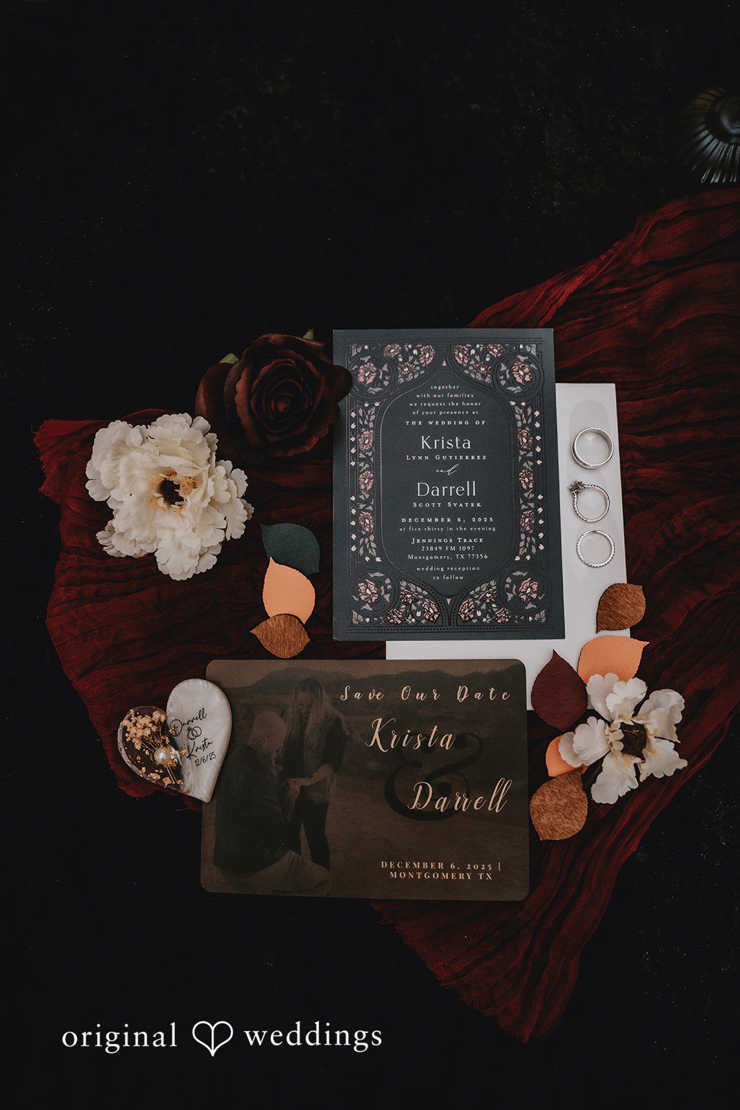 Black wedding invitation suite on red fabric at Jennings Trace.