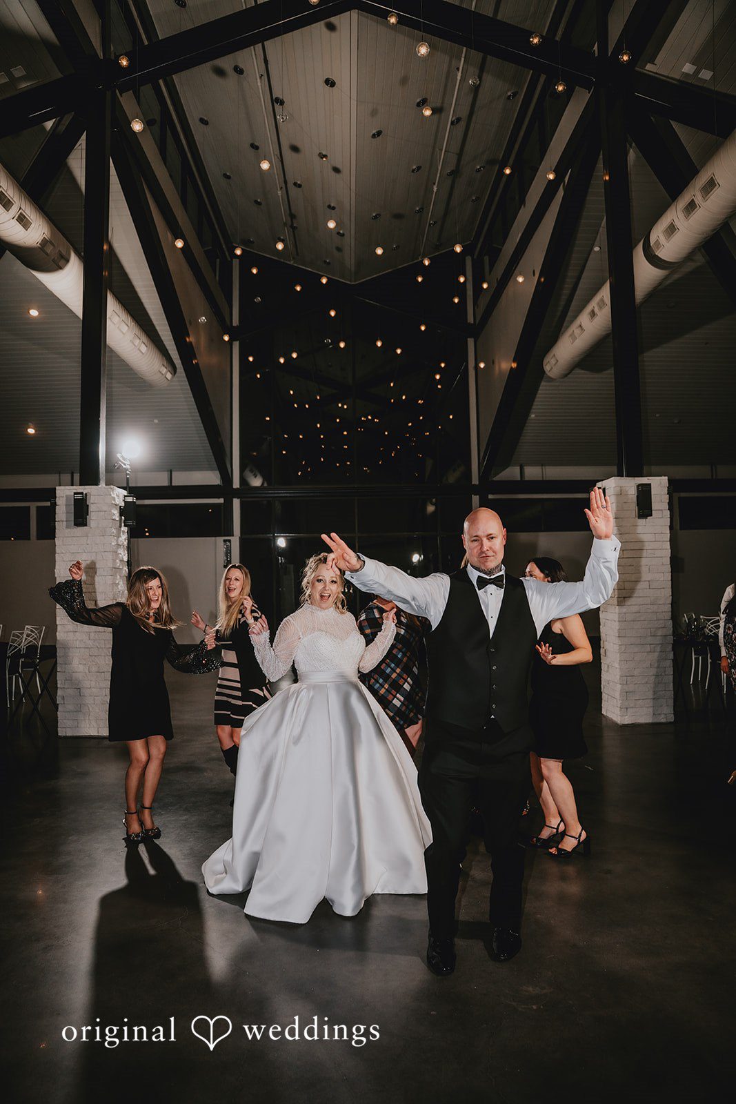 Couple dancing excitedly on dance floor.