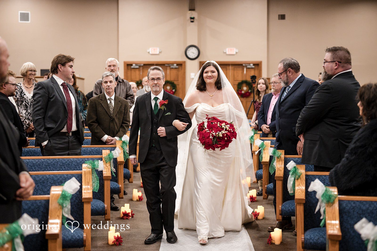 The bride's father walks the bride down the aisle