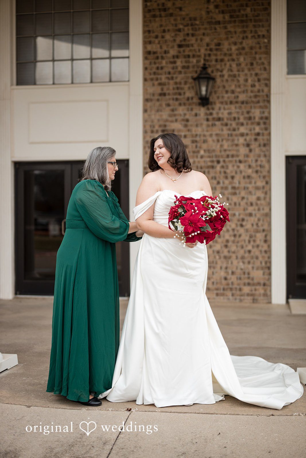 The bride's mother helps get bride ready