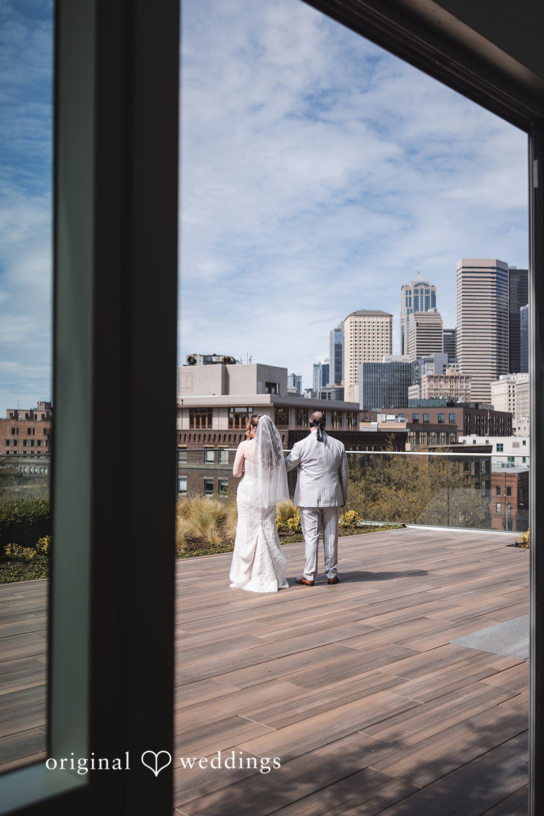 Nicolas + Nicole Wide portrait of the bride and groom outside the venue