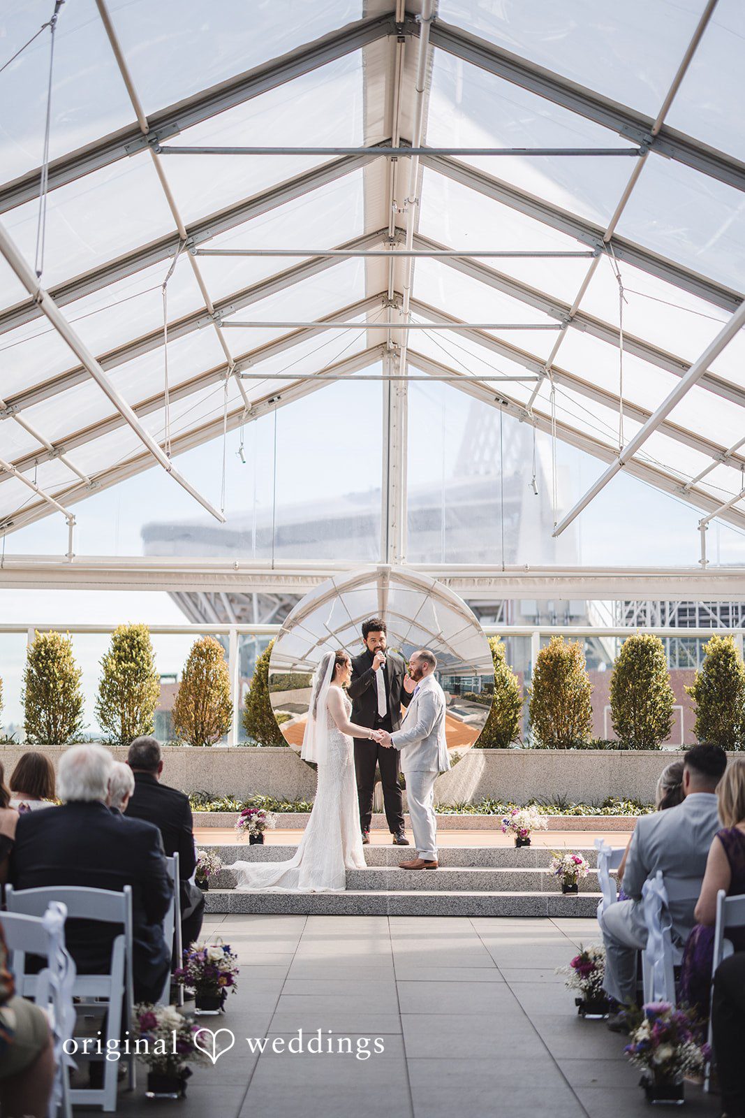Nicolas + Nicole Bride and groom exchanging vows in front of wedding guests