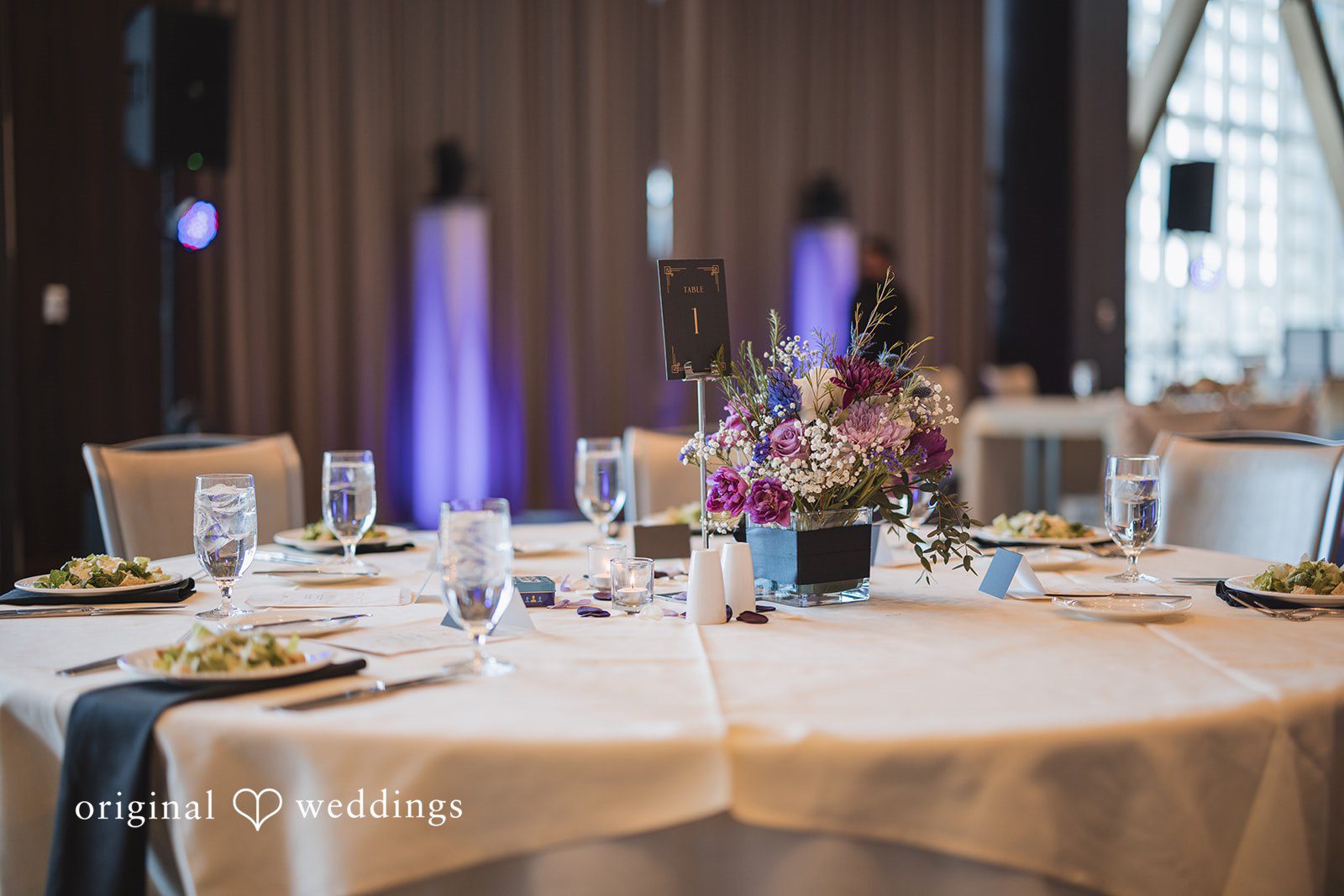 Nicolas + Nicole Close-up of reception table decor with candles and florals