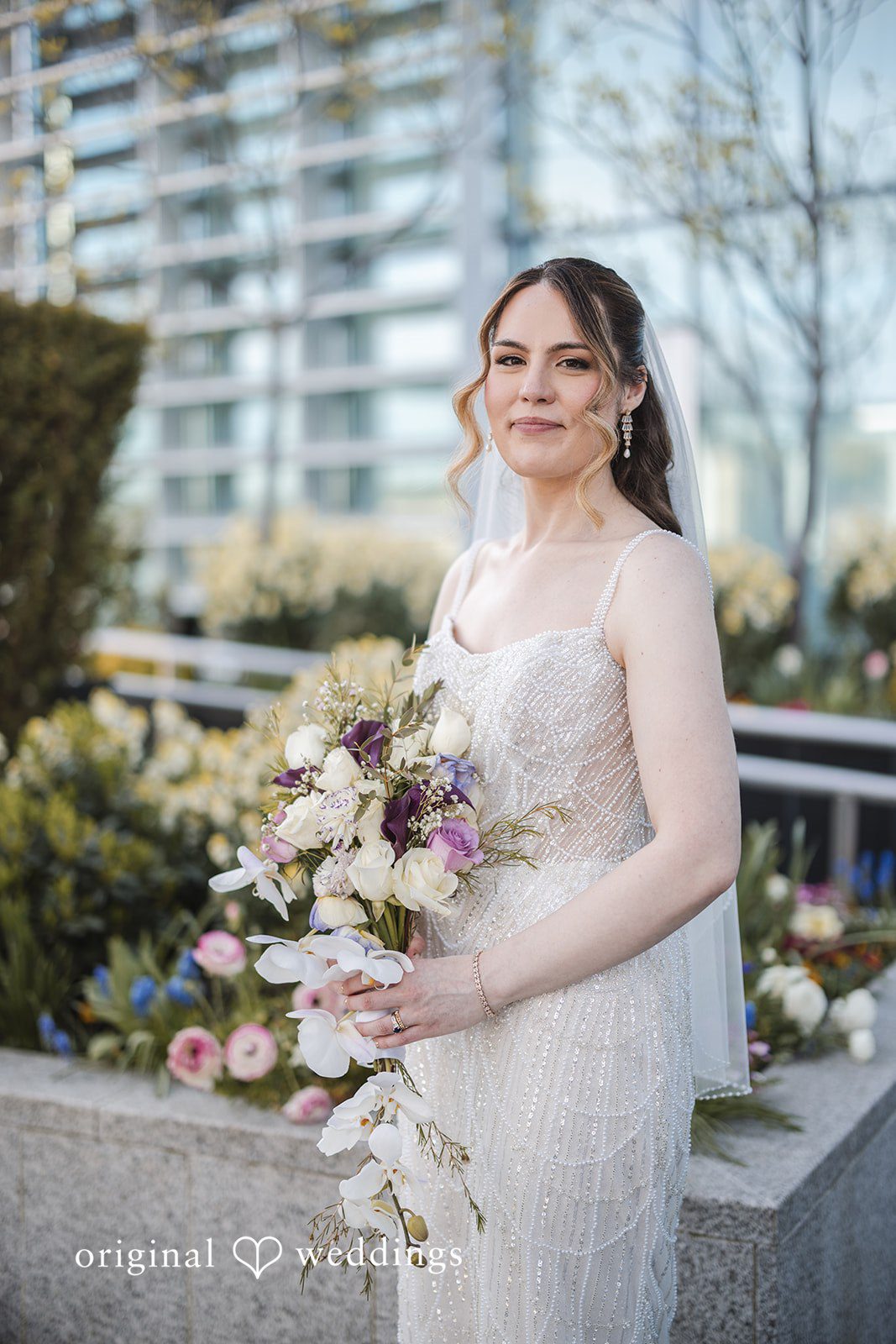Nicolas + Nicole Bride posing with her bouquet during wedding portraits