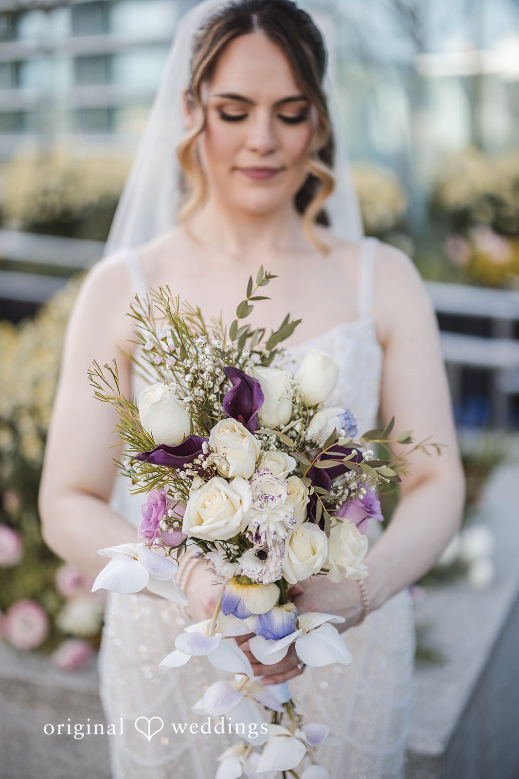 Nicolas + Nicole Close-up portrait of the bride holding her bouquet