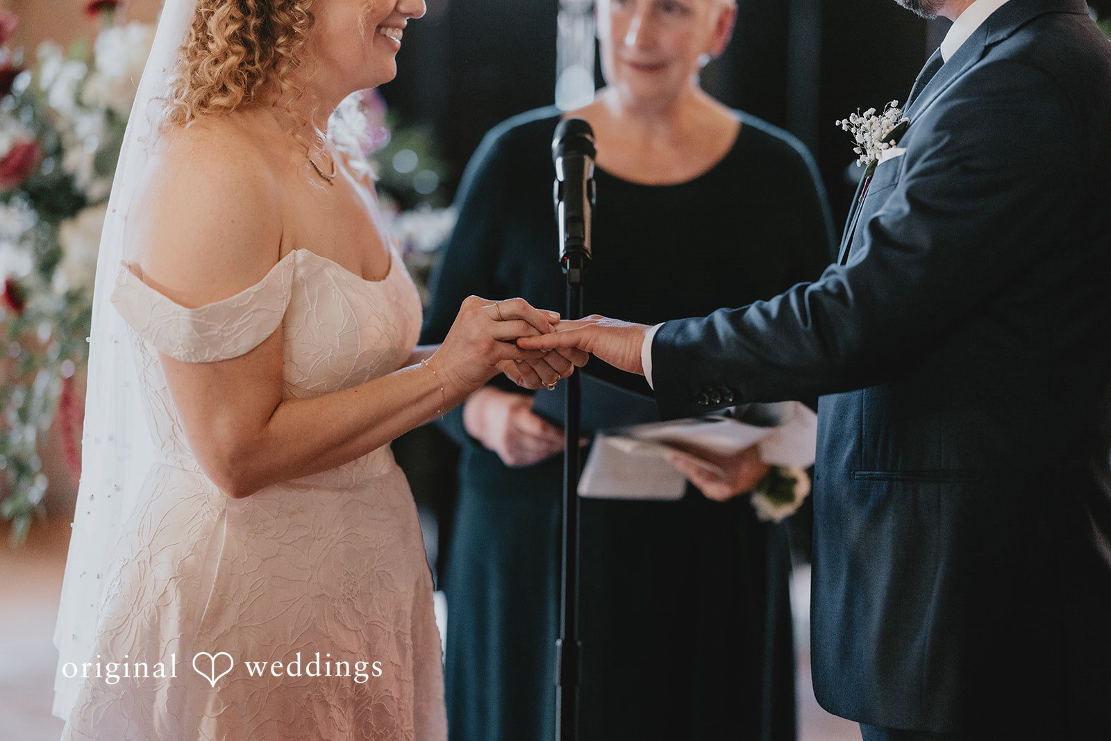 The bride puts the ring on the groom’s finger
