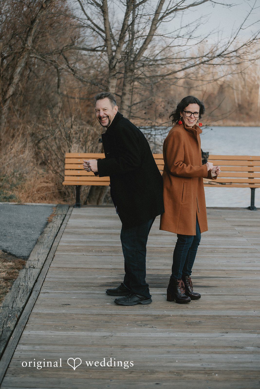 A fun portrait of the couple on the walking path by the lake