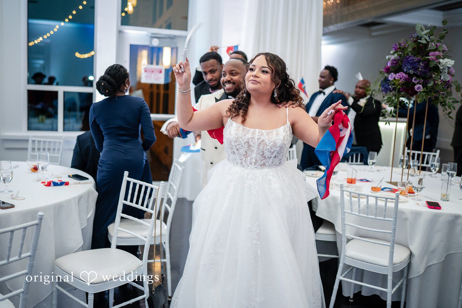 Guests and couple dancing together on the reception dance floor