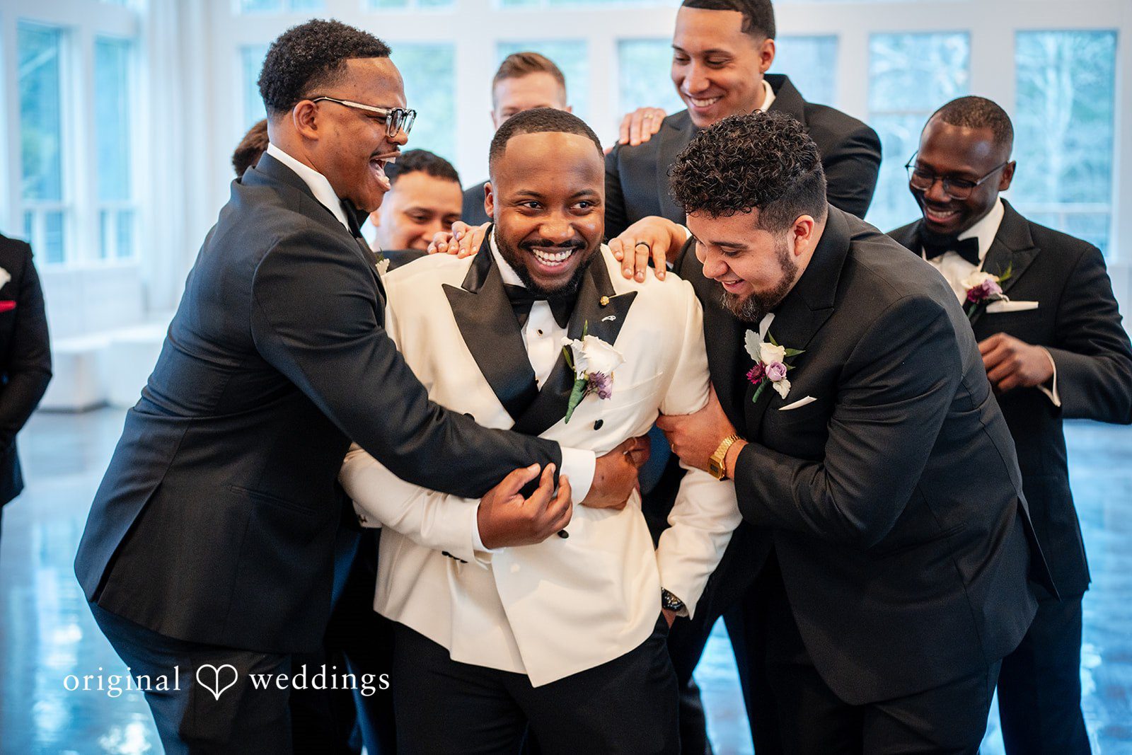 Groom and groomsmen sharing a fun and joyful moment together