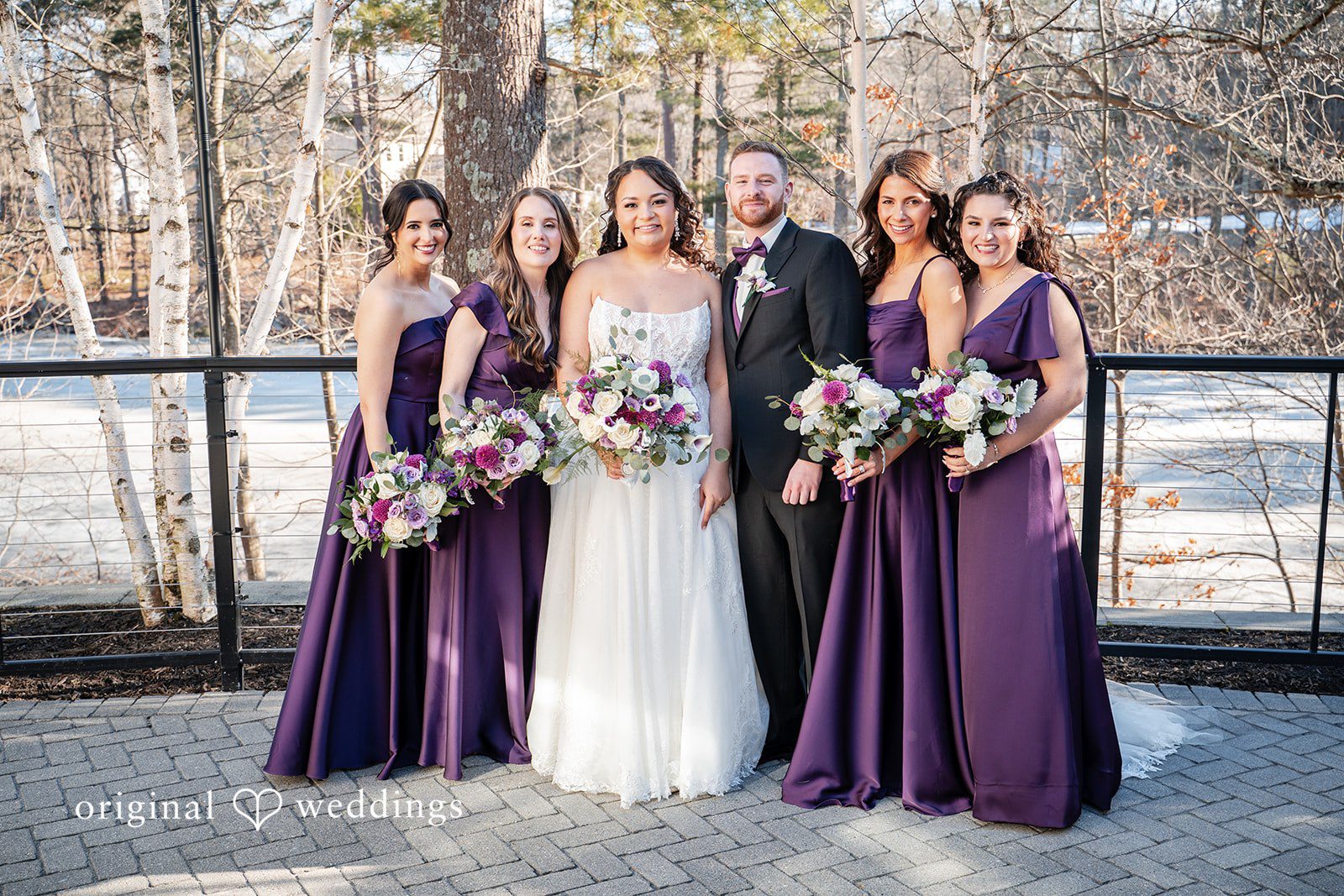 Bride and groom with bridesmaids in an outdoor wedding party portrait