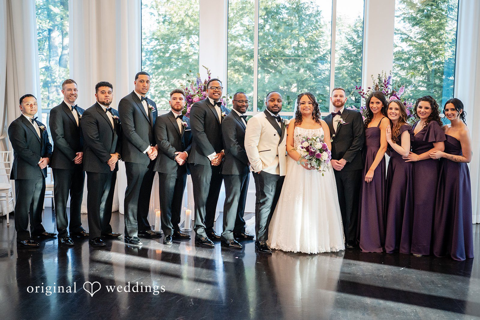 Wedding party group portrait with bride and groom at the venue