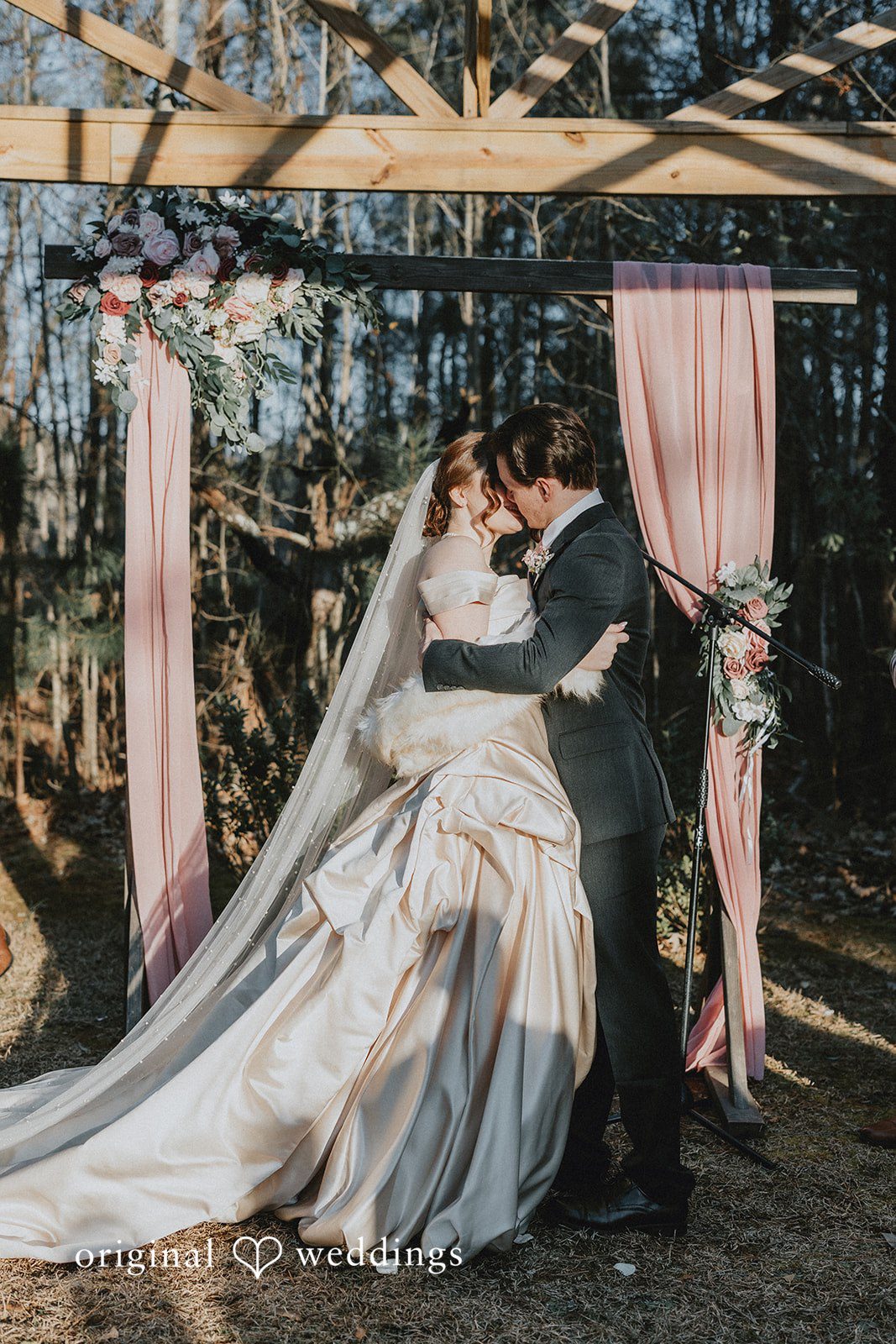 Ayana + Gabriel Bride and groom sharing a kiss at the altar after getting married.