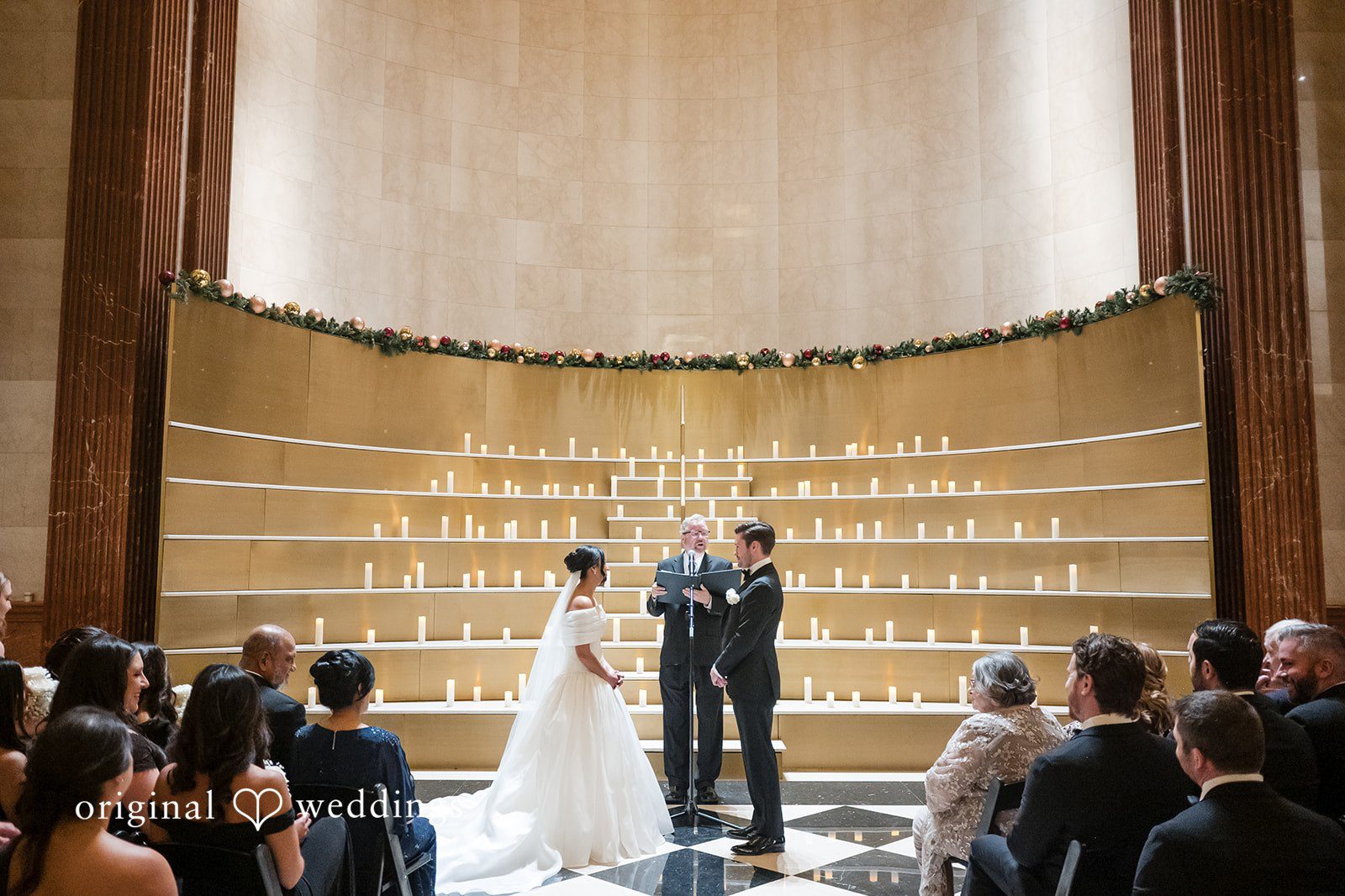 A Couple standing at the altar facing an officiant during a wedding ceremony.