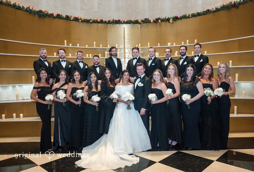 Chicago Wedding Photography by Original Weddings capturing the stunning group photo of couple with guests at Library at 190
