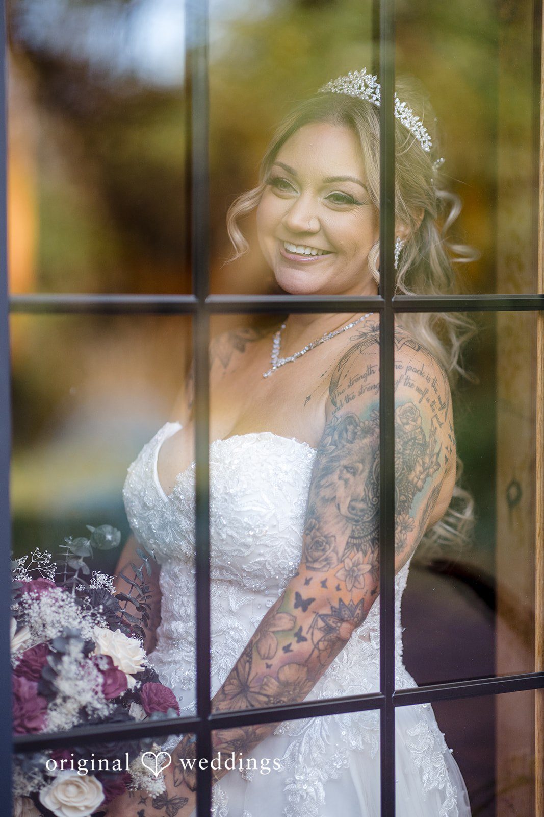 April + Joseph Beautiful bride smiling through window during wedding day