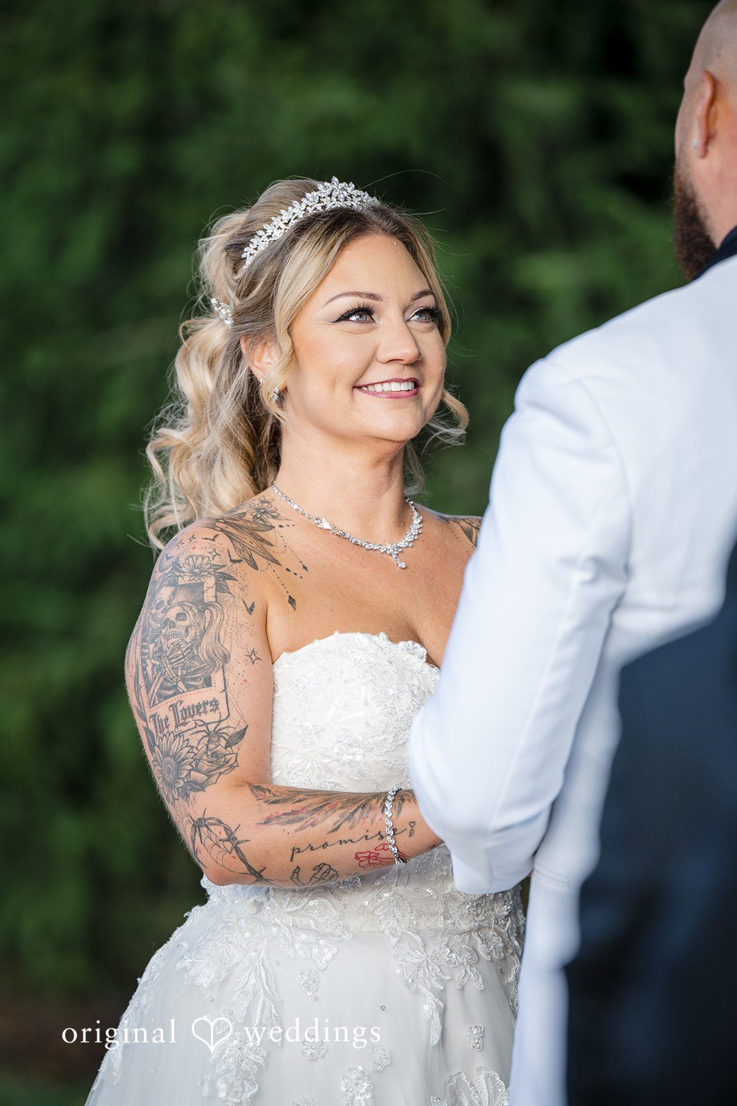April + Joseph Beautiful bride smiling at groom during outdoor wedding ceremony