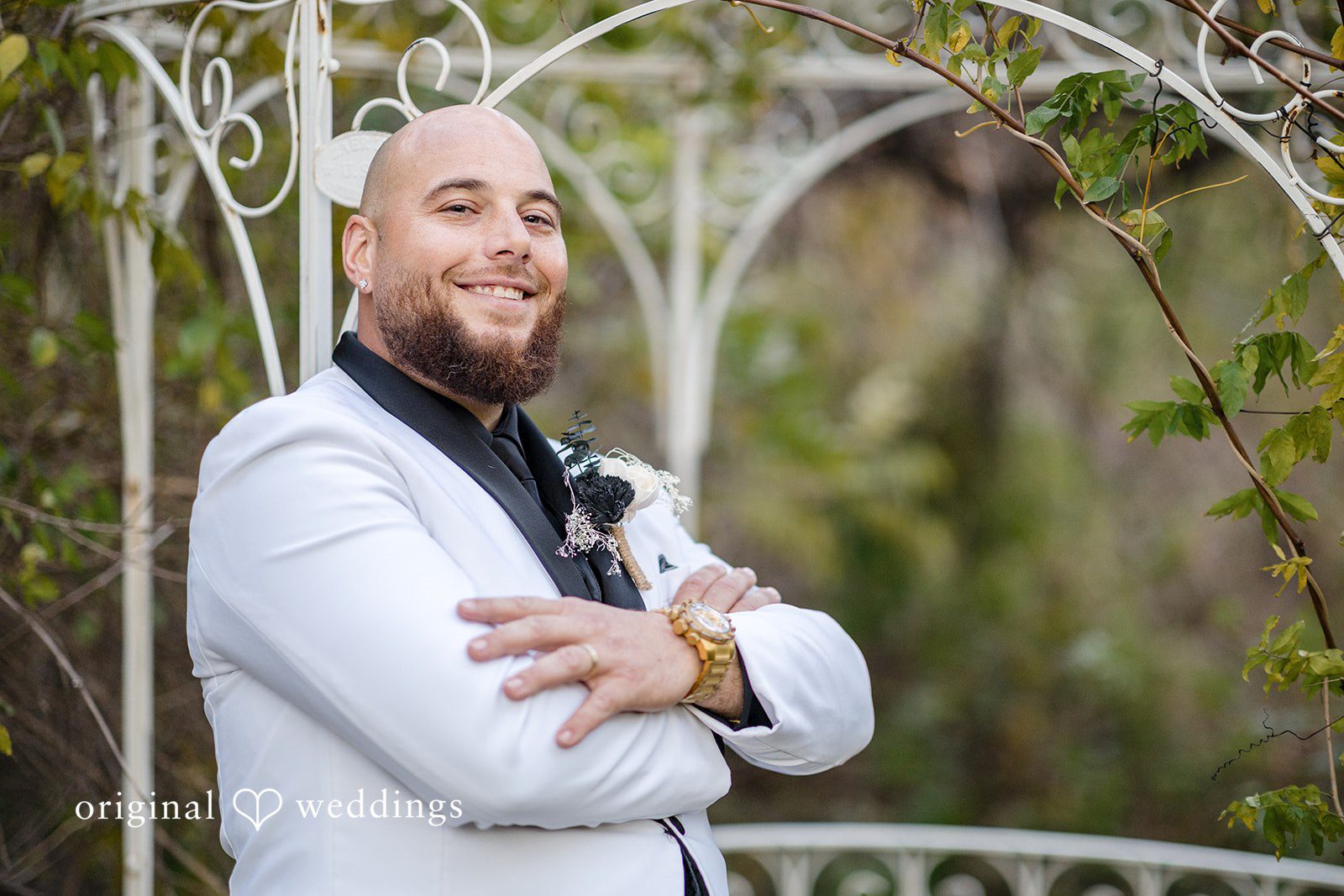 April + Joseph Groom smiling during outdoor wedding photo session