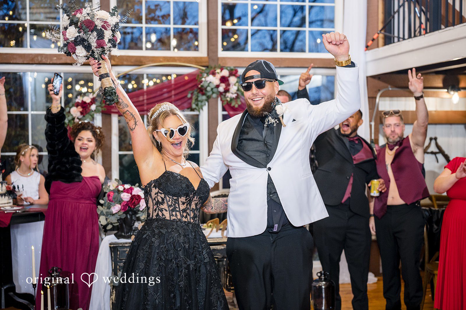 April + Joseph Elegent wedding reception moment with bride holding bouquet high