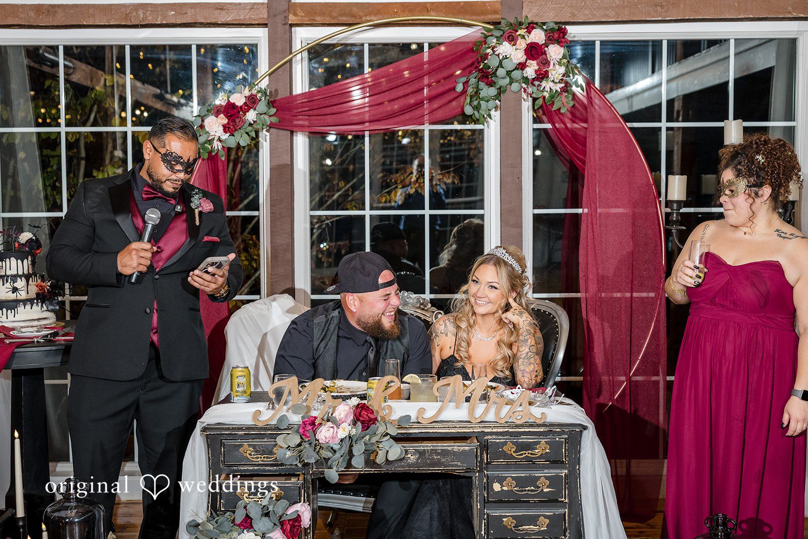 April + Joseph Beautiful wedding reception setup with floral arch and sweetheart table