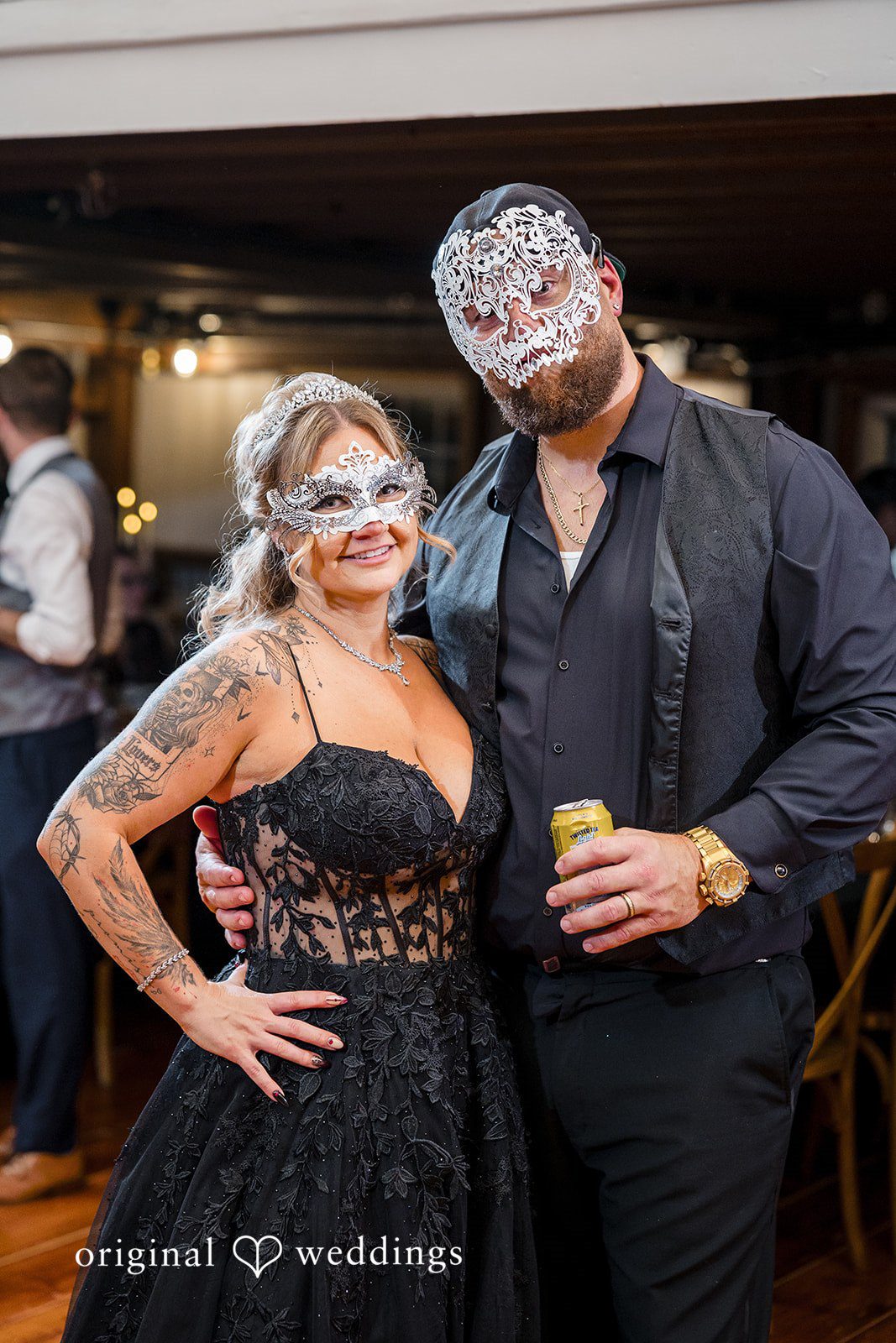 April + Joseph Bride and groom wearing decorative masks during wedding celebration