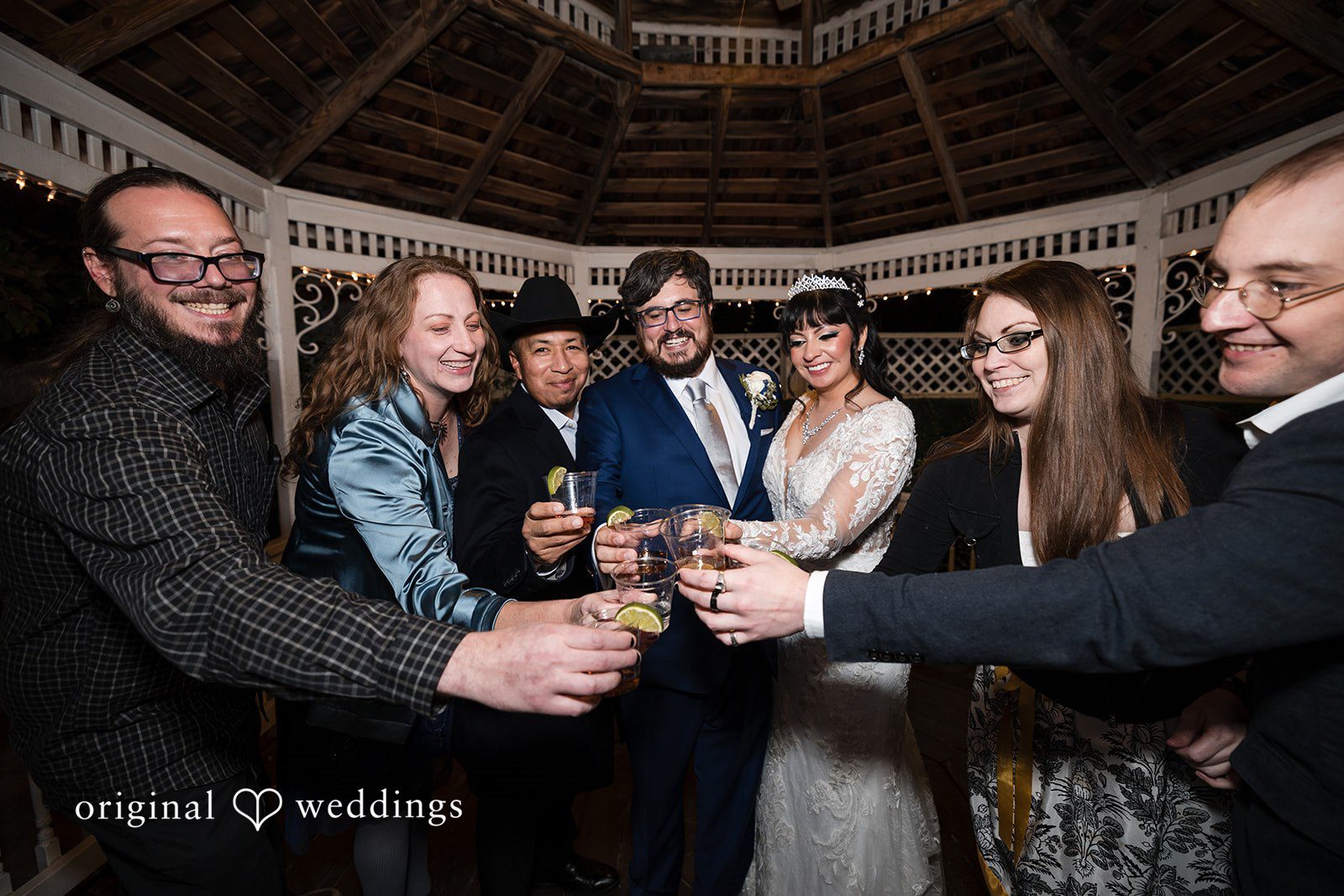 Bride and groom cheering with guests