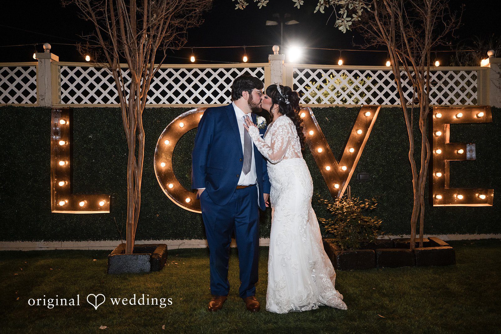 Romantic kiss of bride and groom at Magnolia Gardens on Main