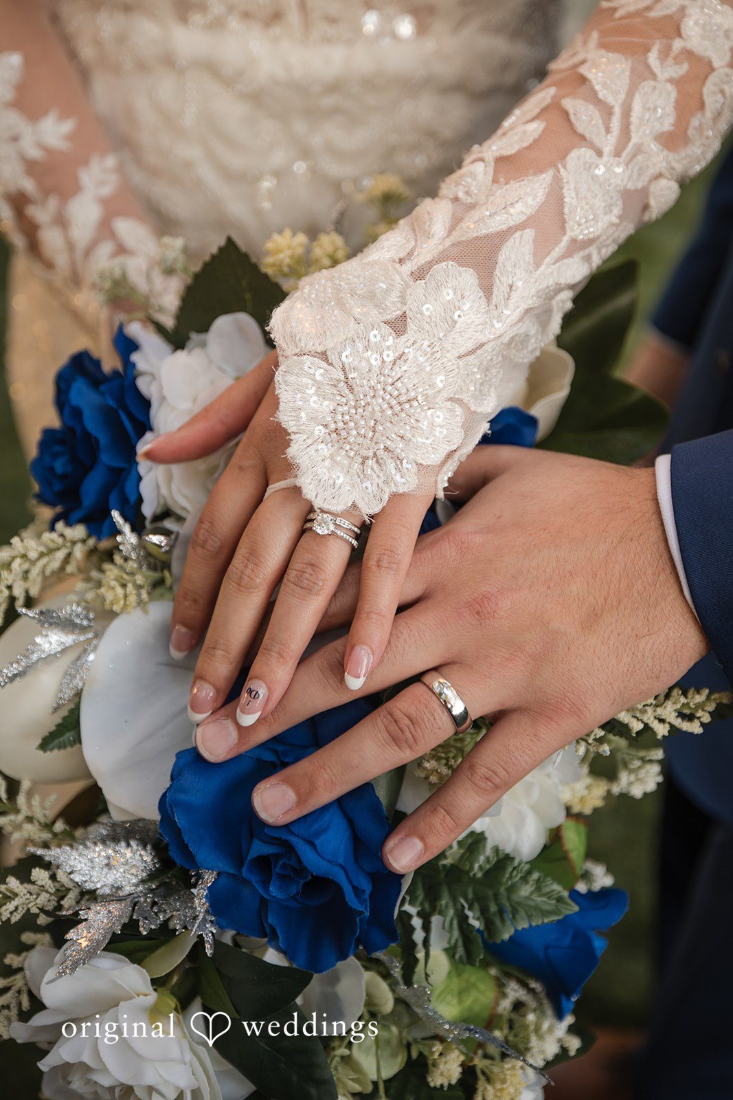 Hands of groom and bride with wedding rings on