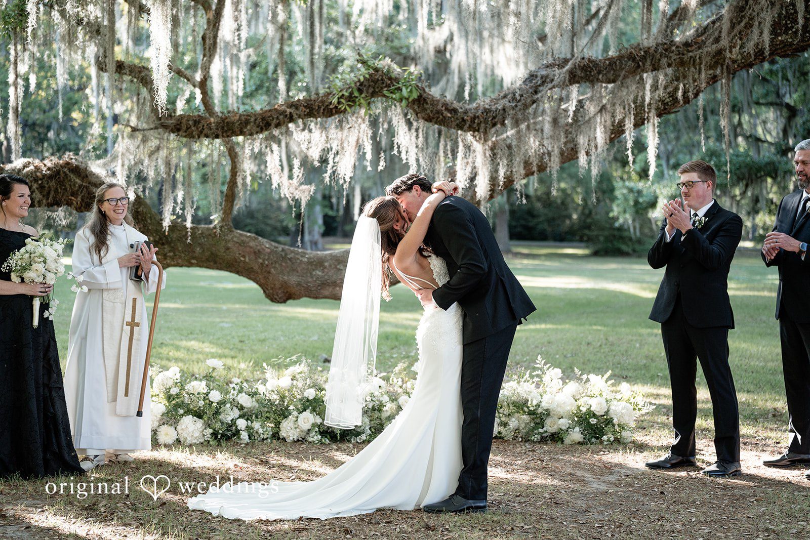 The couple seals their union with a kiss