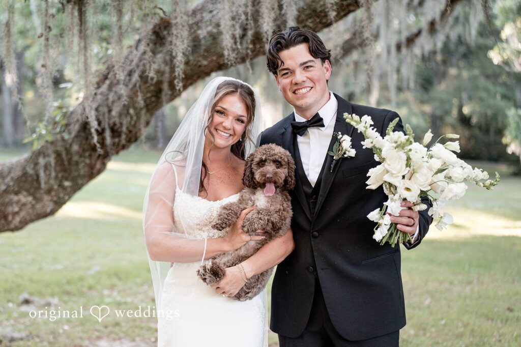 Abrey + Emily Our Charleston wedding photographers captured a stunning portrait of the couple and their pup at the Magnolia Plantation and Gardens