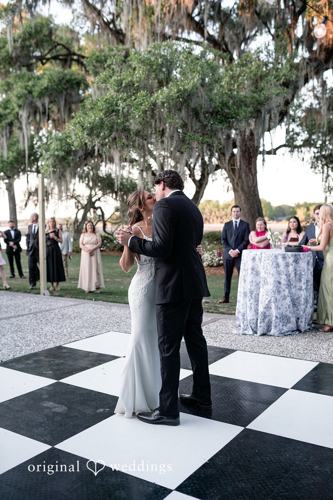 The couple takes their first dance under the open sky