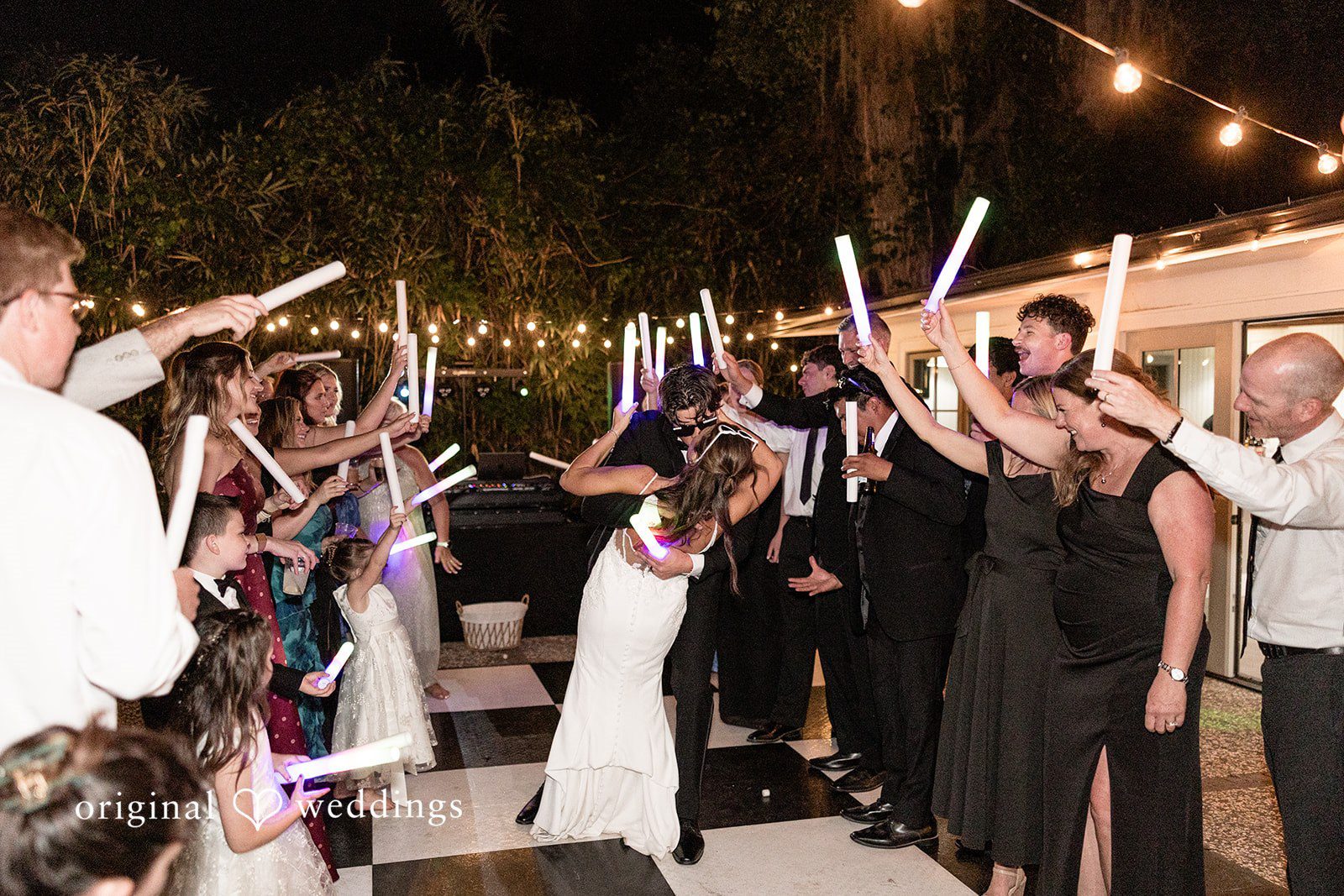 The couple makes a grand exit with cheers from their wedding party