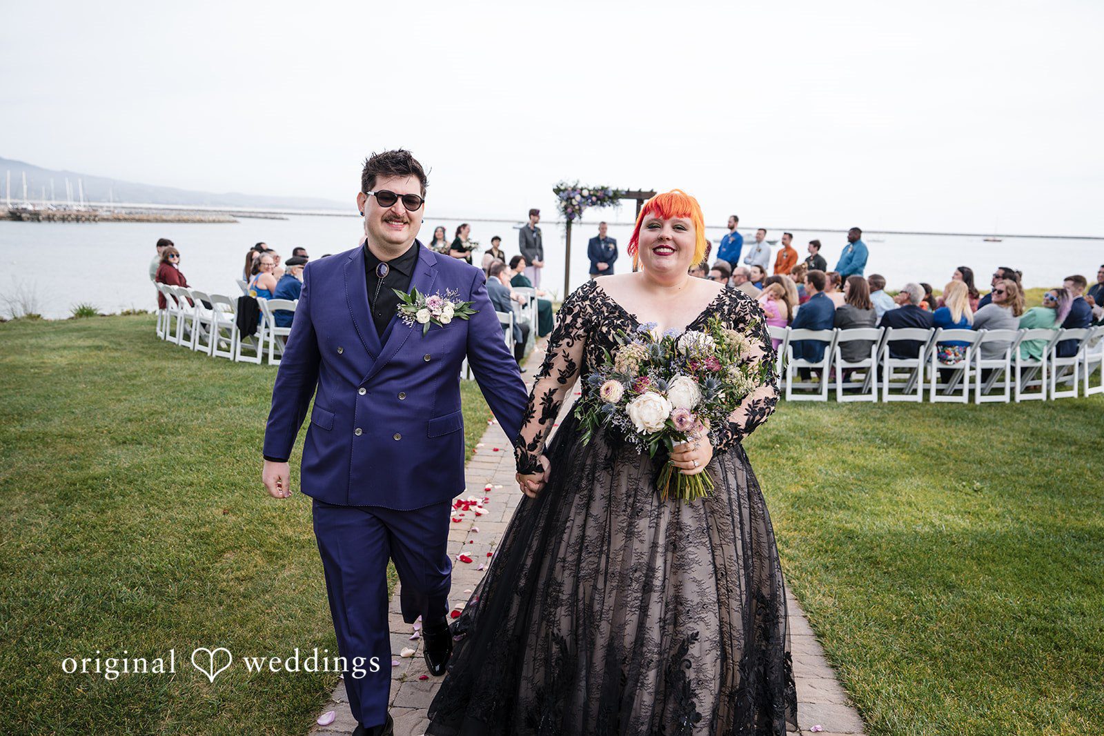 Morgan + Todd Newlyweds walking hand in hand toward the reception
