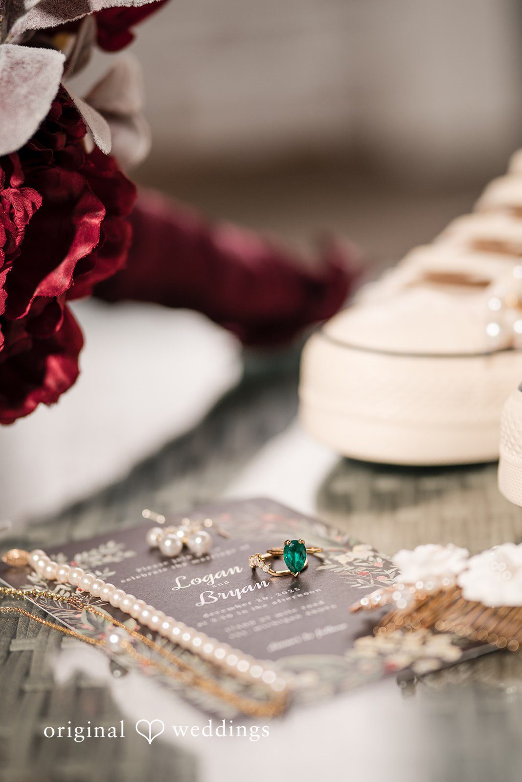 Logan + Bryan Bridal detail arrangement with rings pearls and wedding invitation