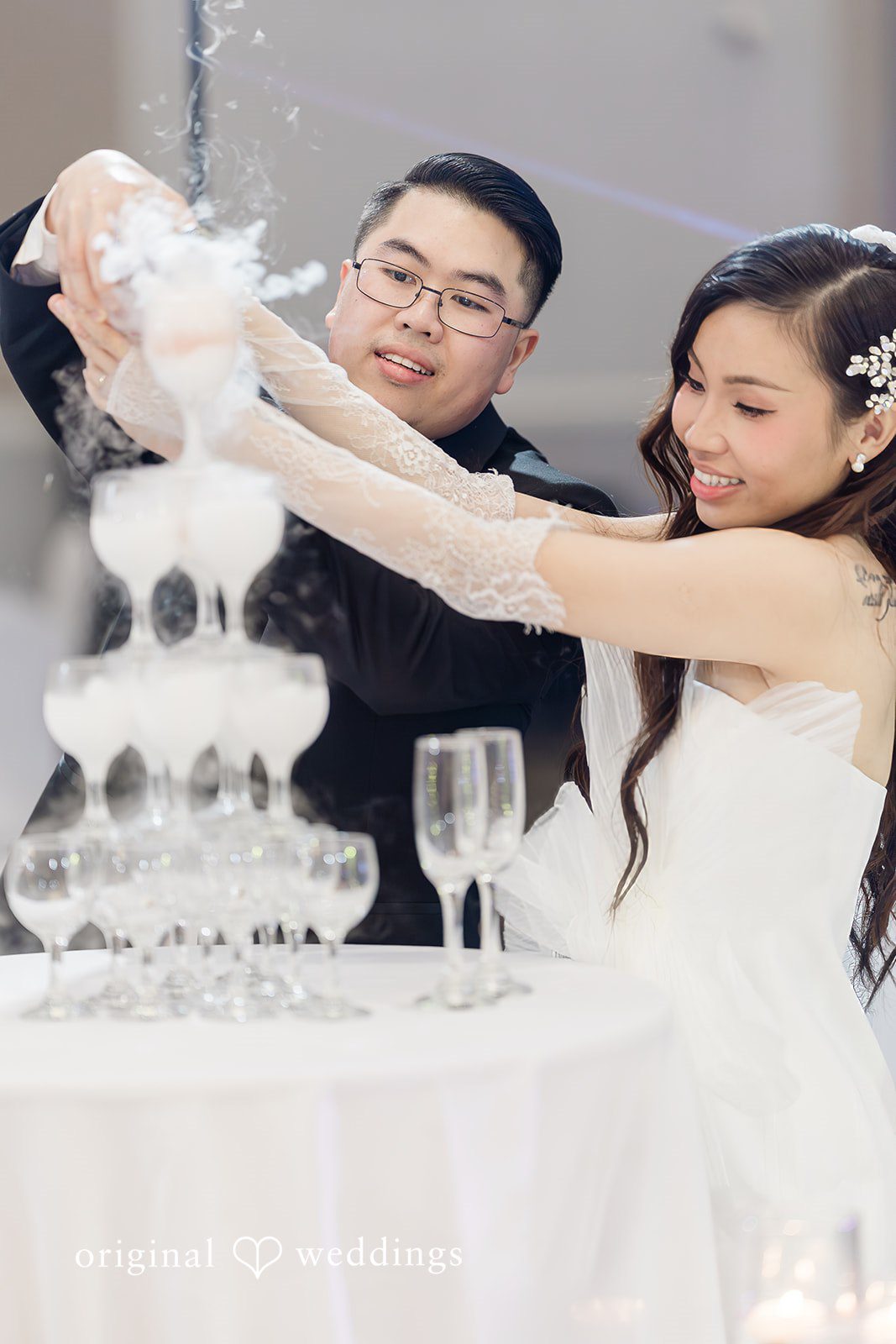 Khanh + Trung Bride and groom toasting drinks during the reception