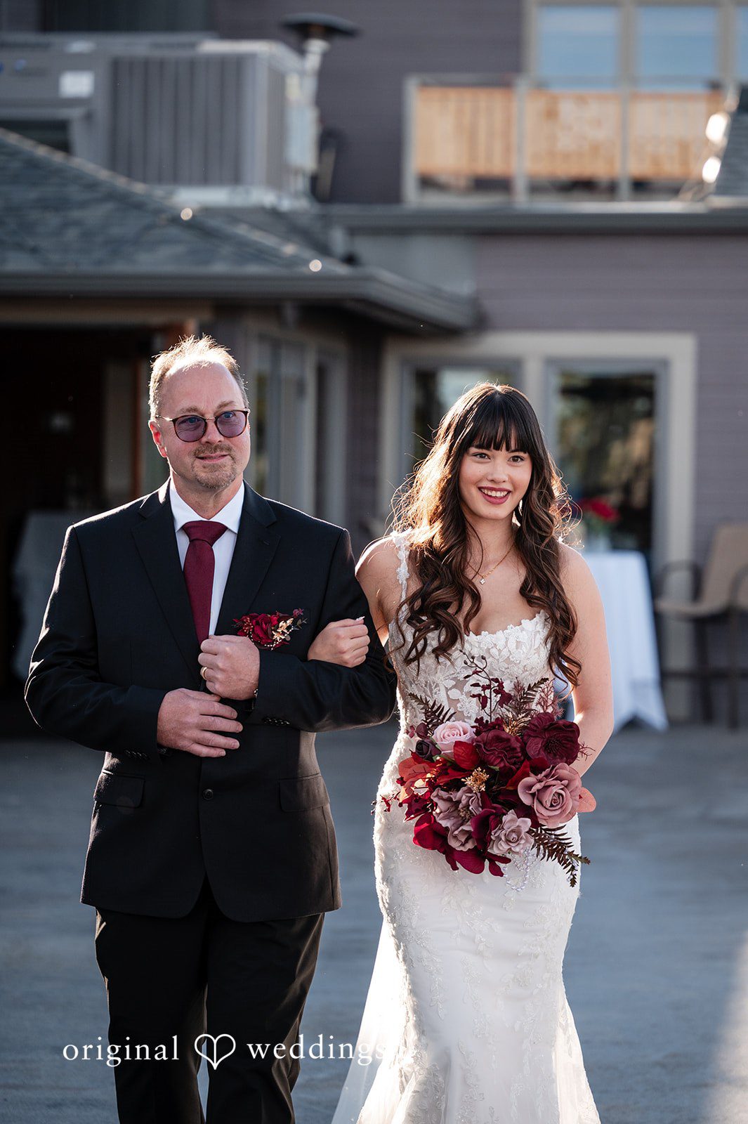 The bride's father walks the bride down the aisle