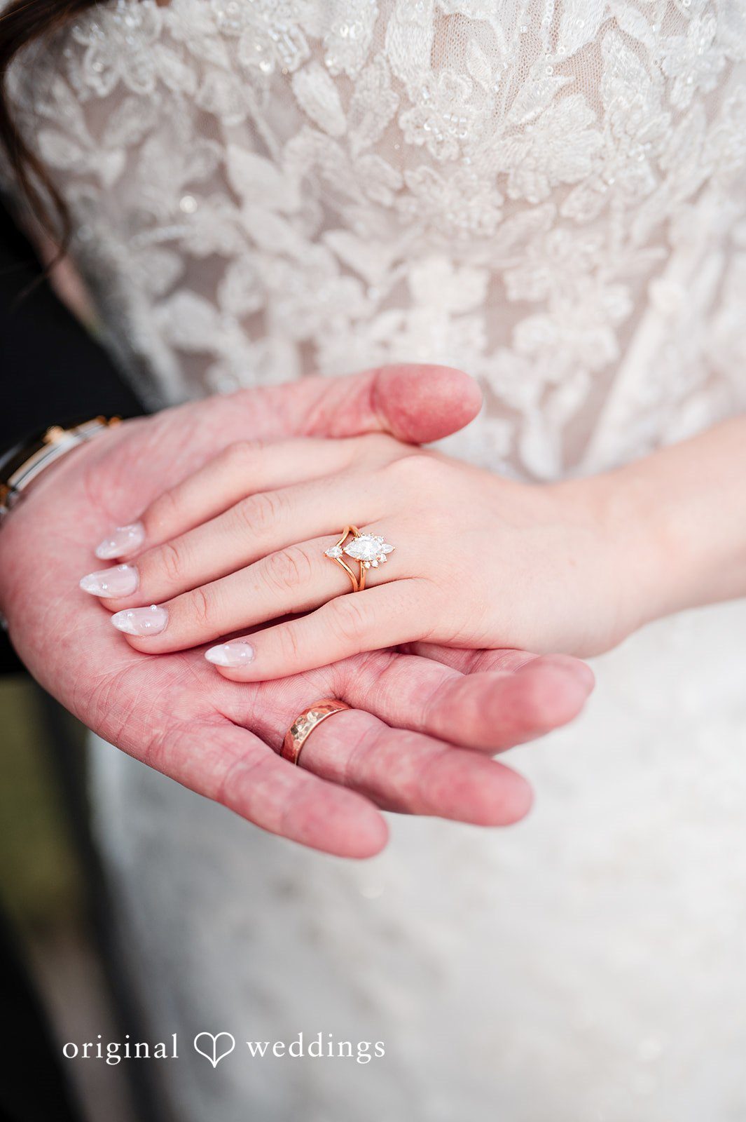 A close-up shot of the couple's fingers