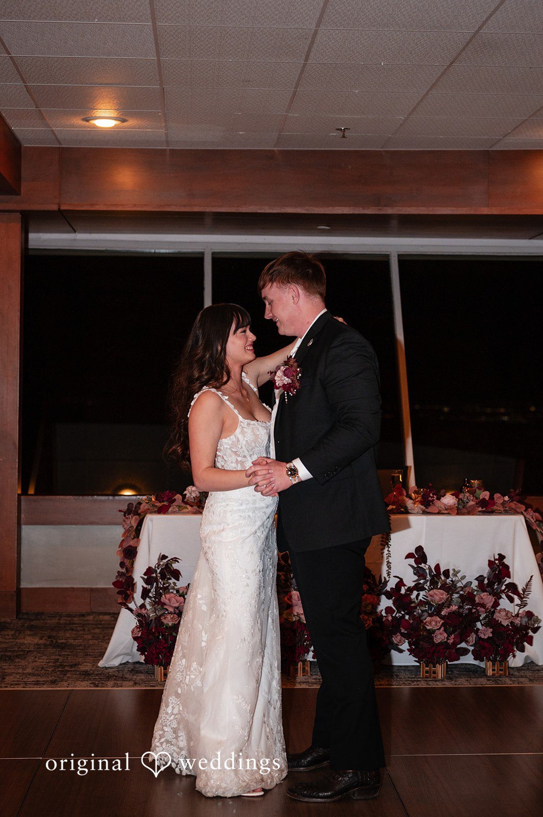 The couple takes their first dance at their wedding reception