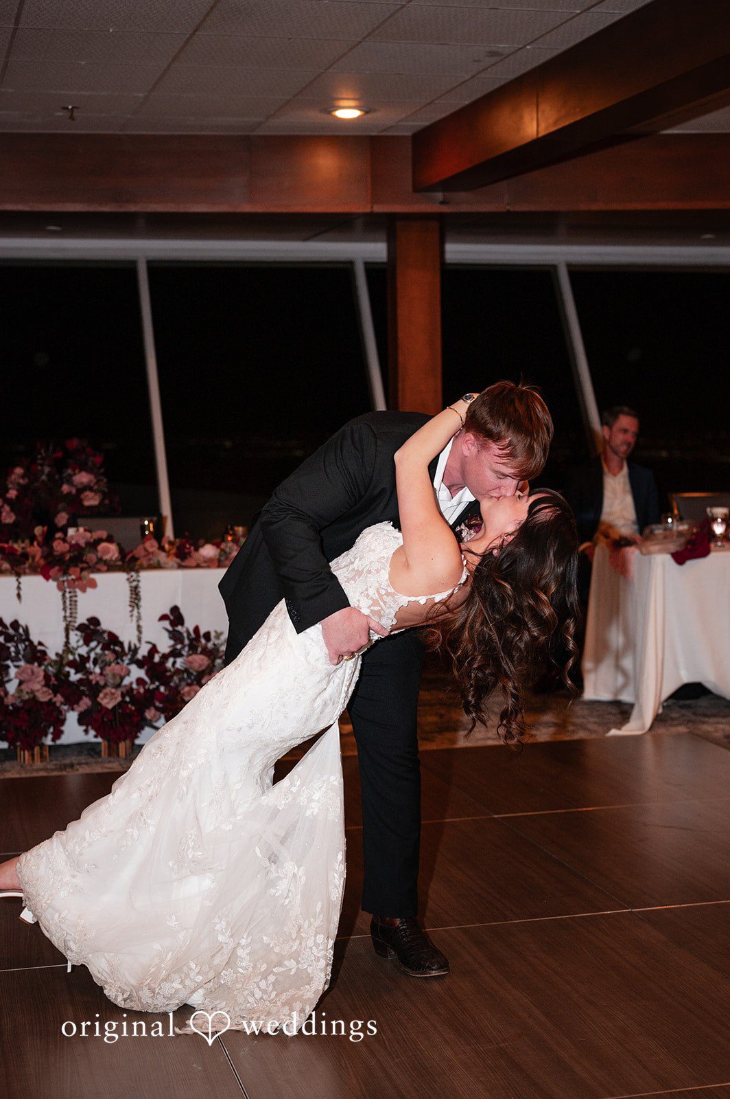 The couple shares a romantic kiss at their wedding reception