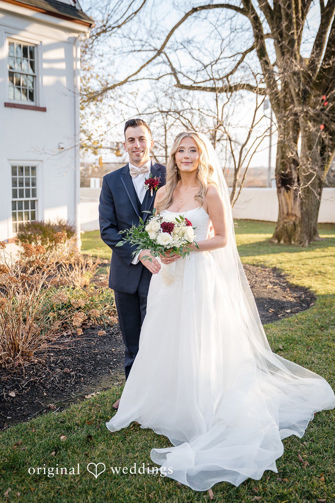 Couple portrait with trees and bouquet details outdoors