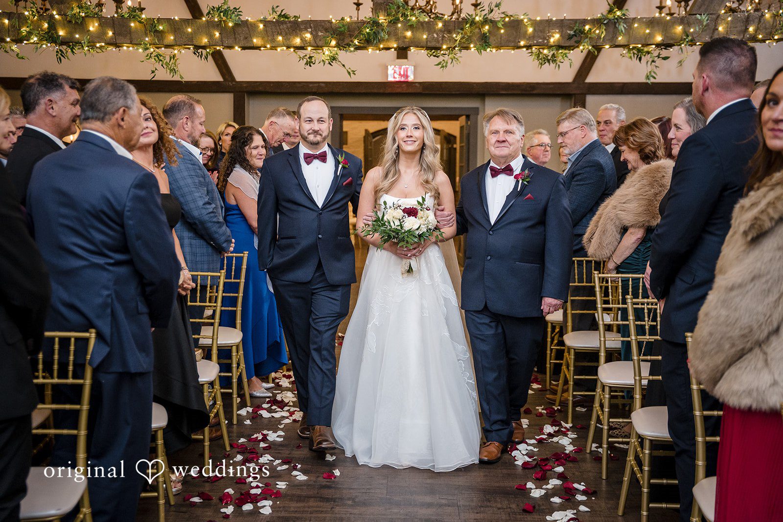 Bride posing with her father and brother before the ceremony