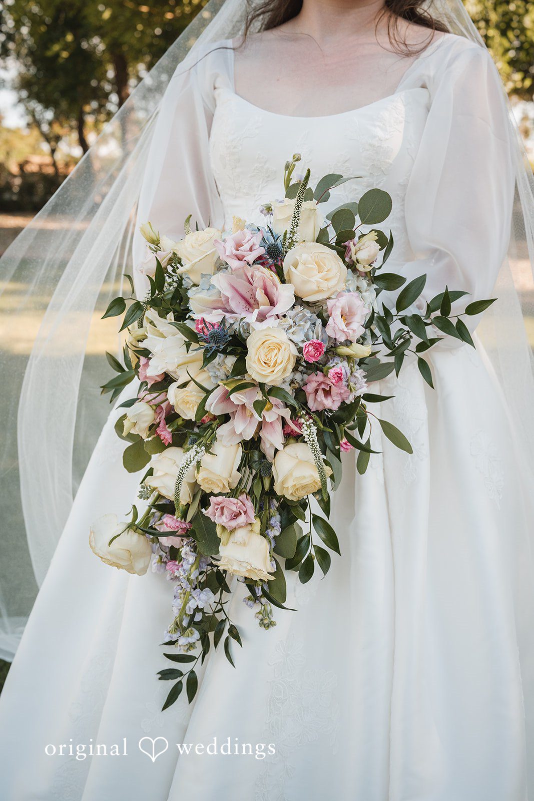A close-up shot of the bride showing her huge bouquet