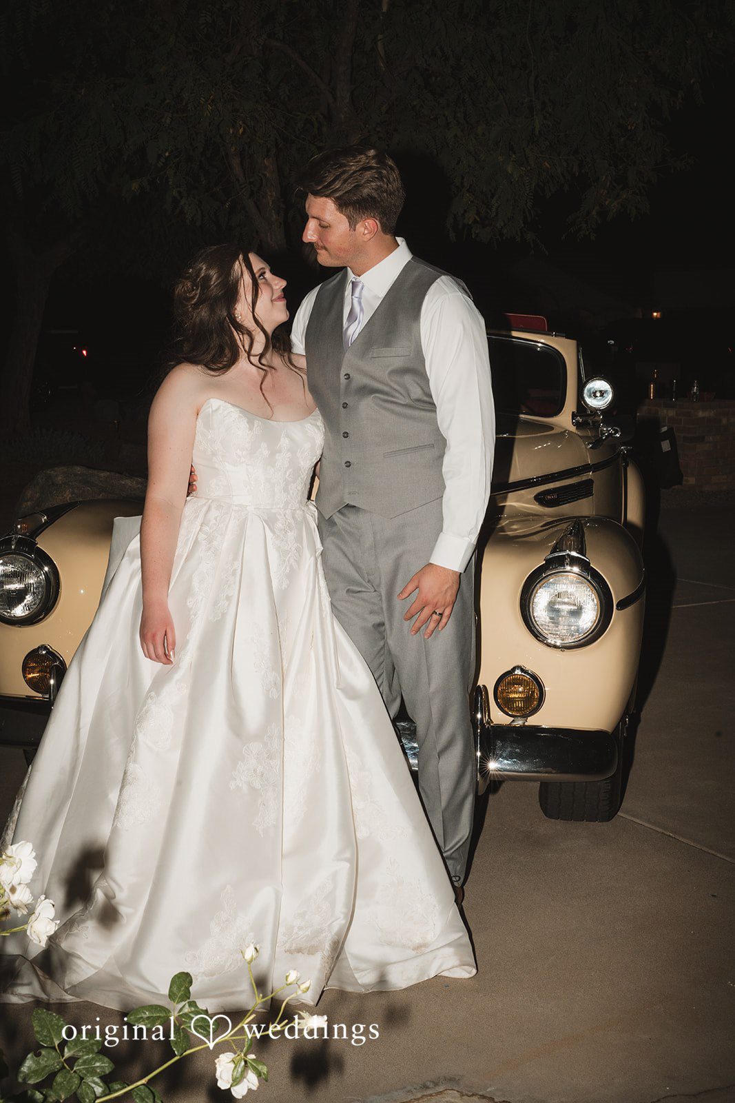 A stunning portrait of the couple by their car